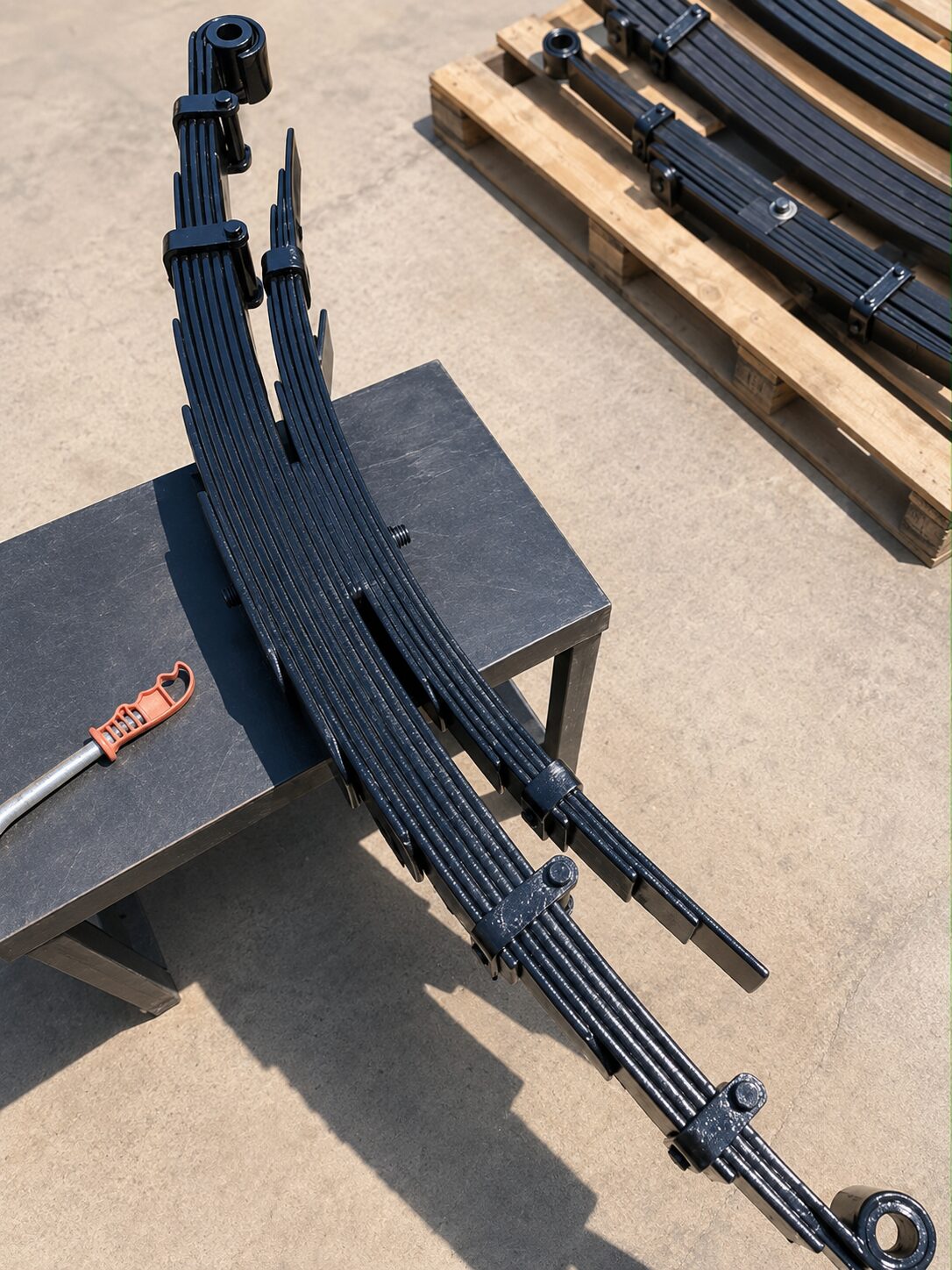 Freshly fabricated multi-leaf spring pack for a Hiace or NV350 on the workbench at Petfetch Springs