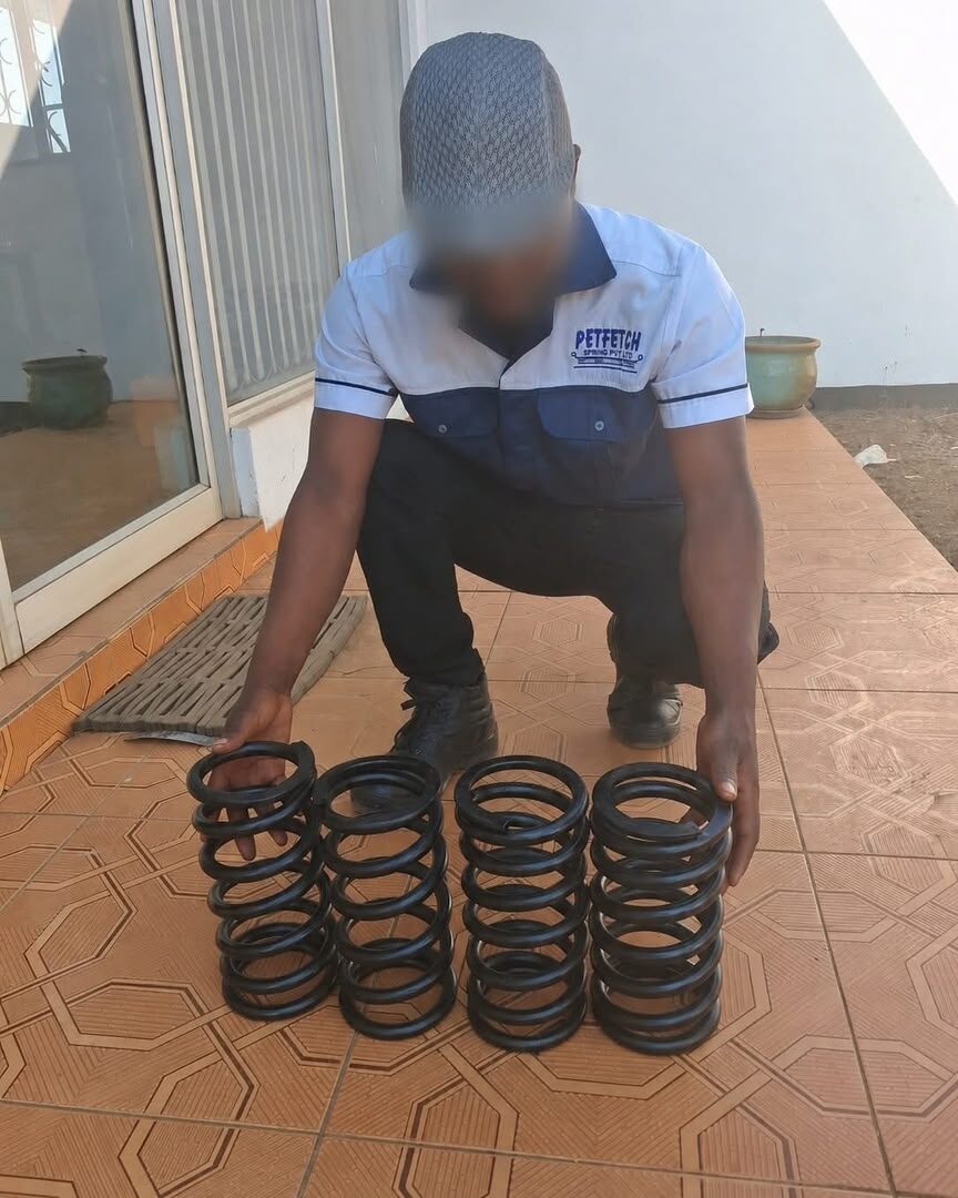 Petfetch Springs technician with a finished set of mining vibro compression coil springs